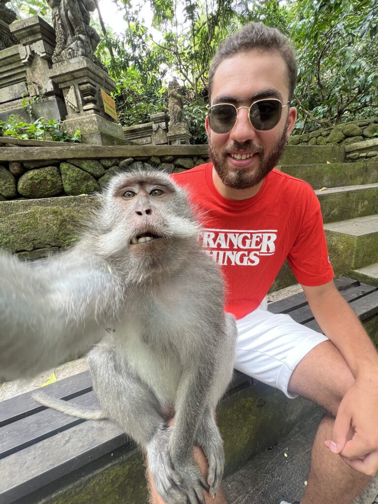 taking a tricky selfie with the monkey in Ubud Bali 