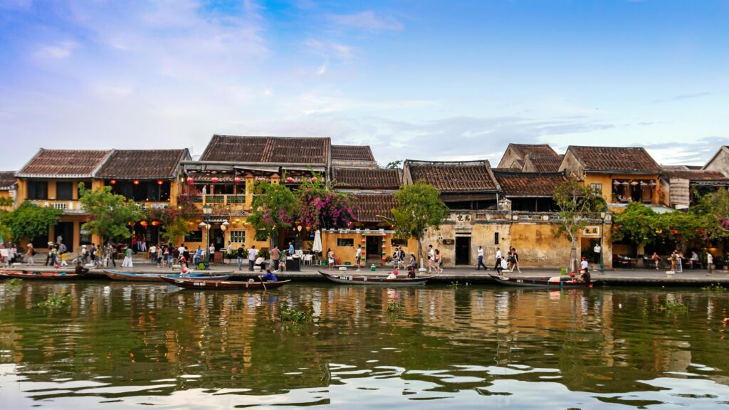 Boats Docked on Canal Near an Old Town