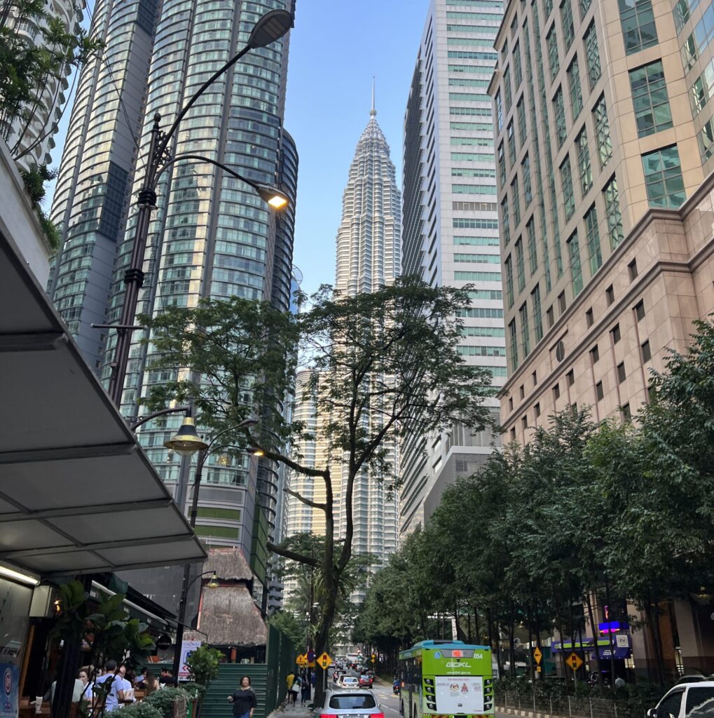 walking around streets of Kuala Lumpur with views of buildings and Twin tower