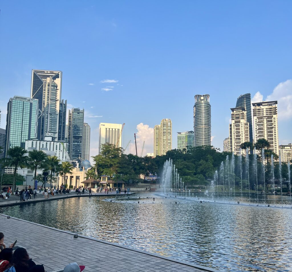 relaxing in klcc garden in my Malaysia 4-Day Itinerary and watching buildings and nature