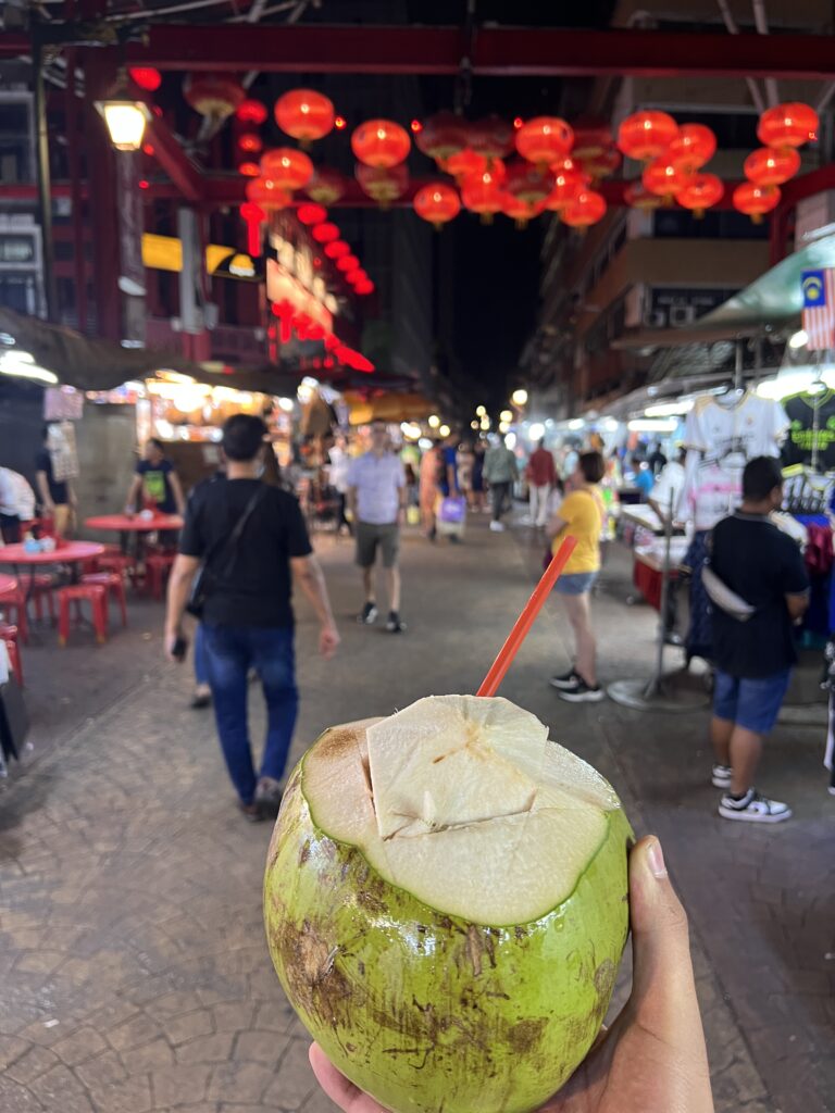 drink coconut in Chinatown in KL at night local street food