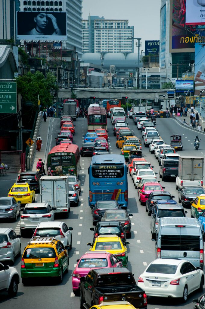 A bustling scene of cars and buses in a traffic jam on Bangkok's expressway.