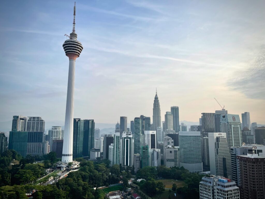 Dramatic view of Kuala Lumpur's skyline featuring the iconic Menara Tower.